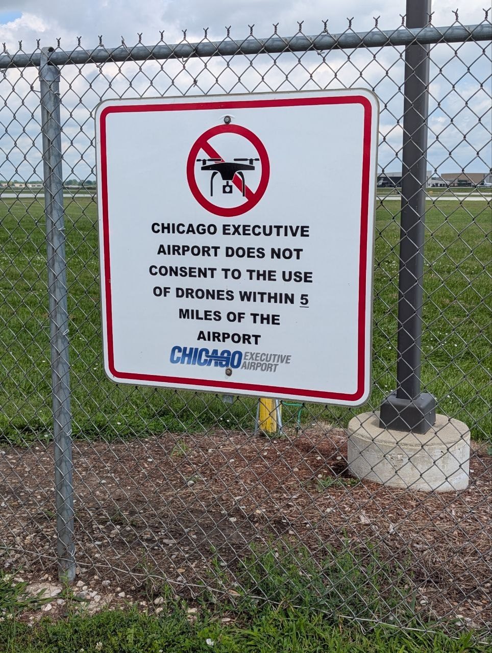 A sign on the airport fence reading “Chicago Executive Airport does not consent to the use of drones within 5 miles of the airport”